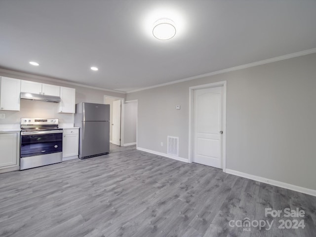 kitchen with white cabinets, ornamental molding, stainless steel appliances, and light hardwood / wood-style floors