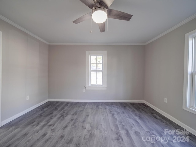 spare room featuring ceiling fan, wood-type flooring, and crown molding