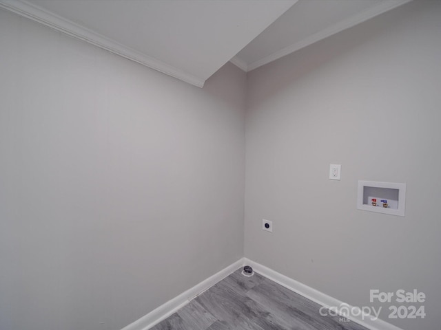 clothes washing area with washer hookup, electric dryer hookup, crown molding, and hardwood / wood-style flooring