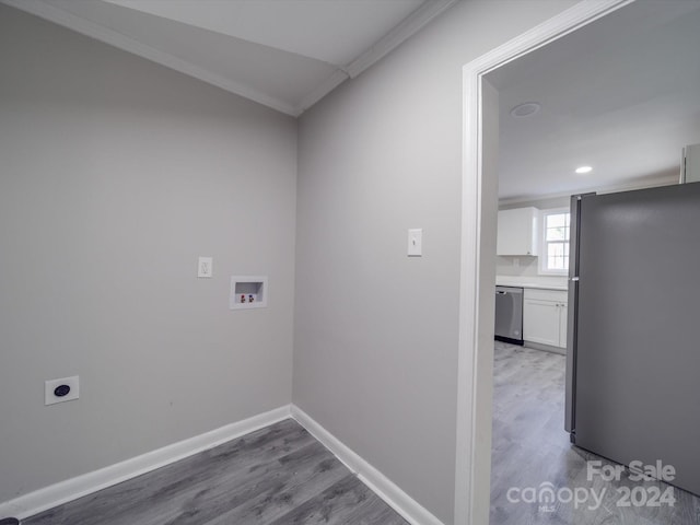 laundry room with hookup for an electric dryer, hardwood / wood-style floors, washer hookup, and ornamental molding