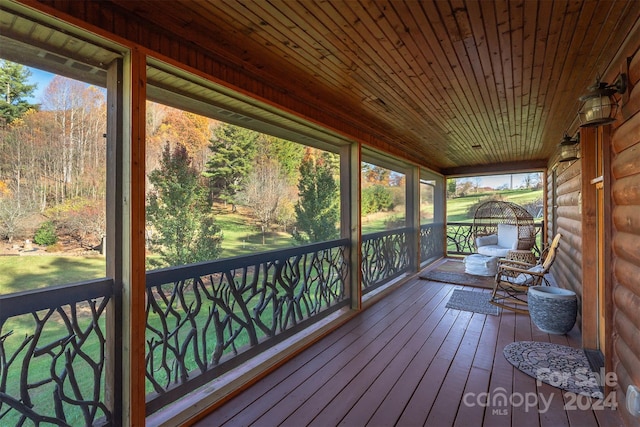 unfurnished sunroom with wooden ceiling