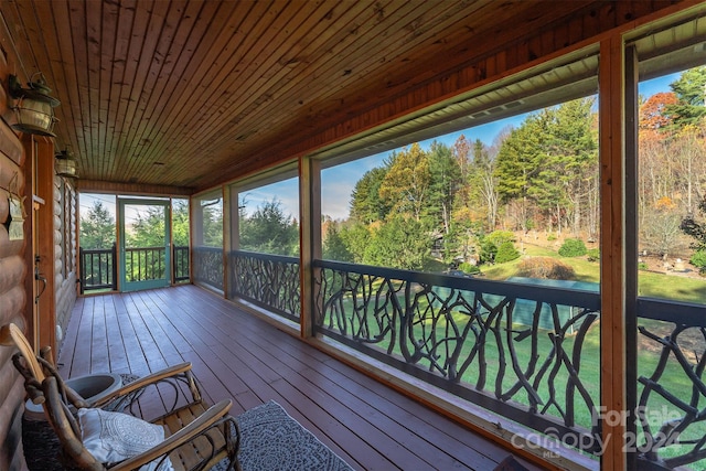 unfurnished sunroom with a healthy amount of sunlight and wooden ceiling