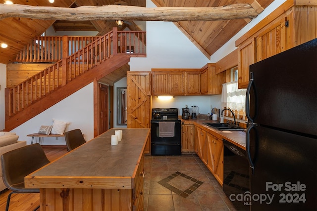 kitchen with wooden ceiling, beamed ceiling, black appliances, tile counters, and sink