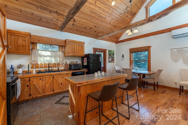 kitchen with wooden ceiling, vaulted ceiling with beams, black appliances, dark wood-type flooring, and a center island