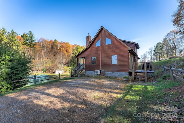 view of side of property featuring a wooden deck