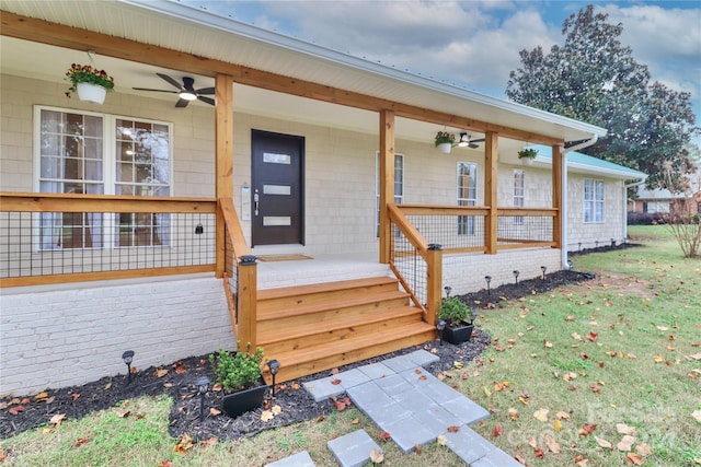 exterior space with ceiling fan, a front lawn, and a porch