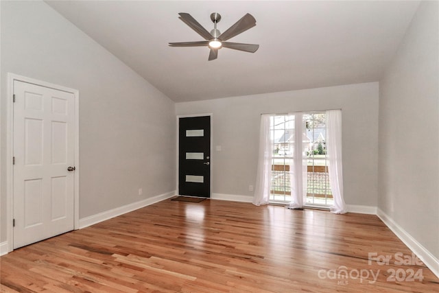 entryway featuring ceiling fan, lofted ceiling, and light wood-type flooring