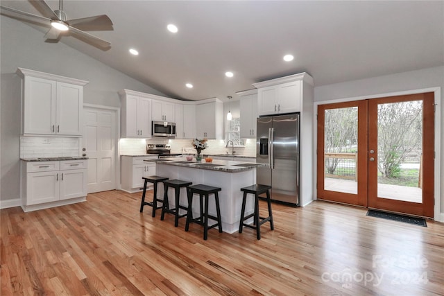 kitchen featuring white cabinets, appliances with stainless steel finishes, and light wood-type flooring