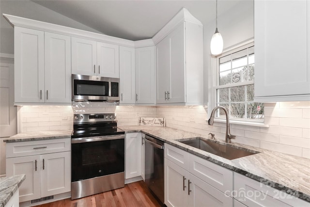 kitchen featuring sink, white cabinets, and appliances with stainless steel finishes