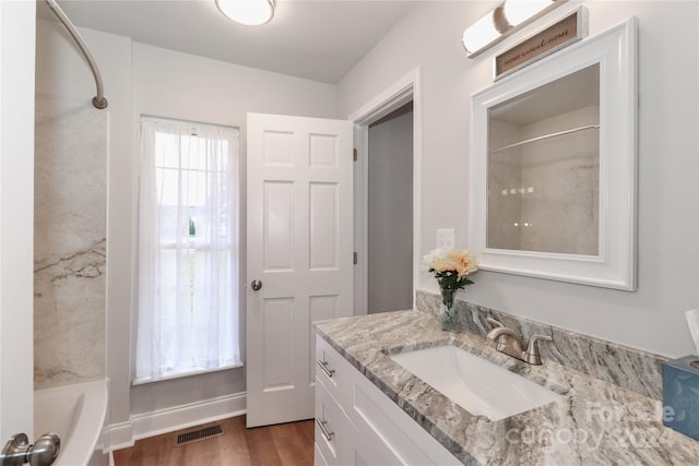 bathroom featuring shower / bathing tub combination, hardwood / wood-style floors, and vanity