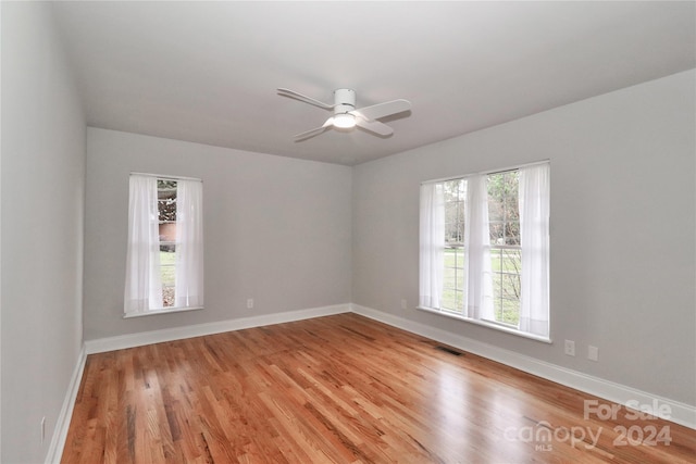 unfurnished room with ceiling fan and light wood-type flooring