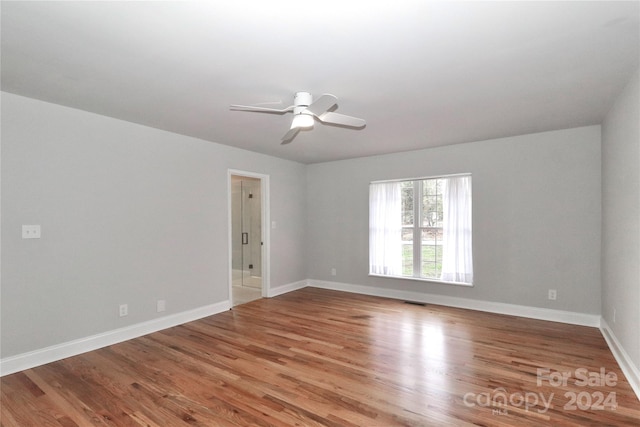 empty room featuring ceiling fan and hardwood / wood-style flooring