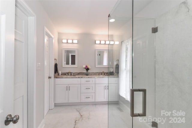 bathroom featuring vanity and an enclosed shower