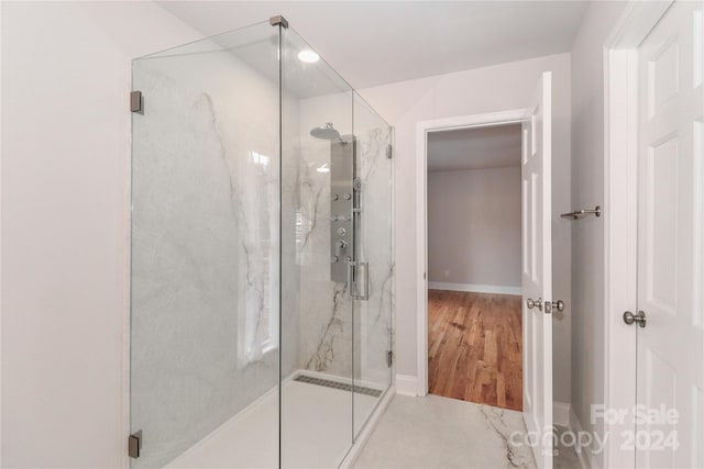 bathroom featuring wood-type flooring and walk in shower