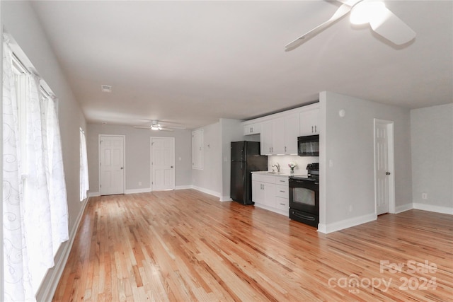 unfurnished living room with light hardwood / wood-style floors, ceiling fan, and sink