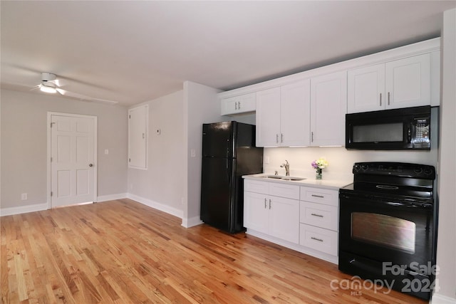 kitchen featuring white cabinets, sink, light hardwood / wood-style floors, and black appliances