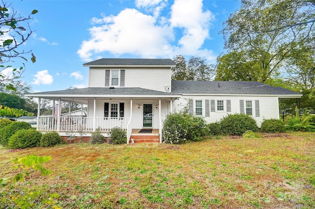 farmhouse-style home featuring a porch and a front lawn