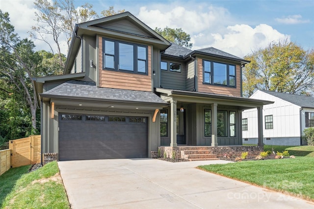 view of front of property with a garage and a front lawn