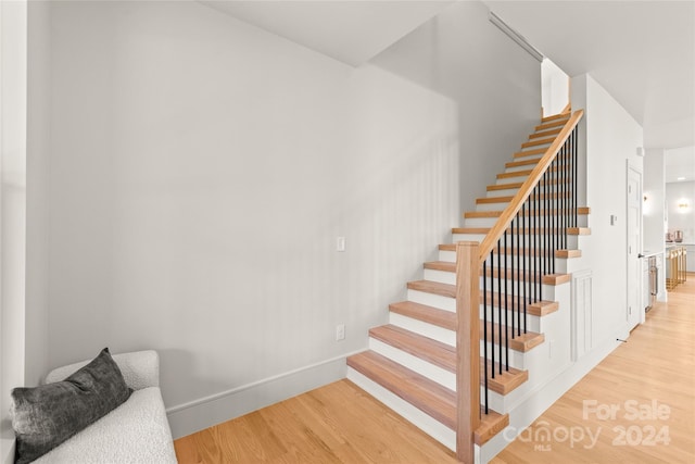 staircase featuring wood-type flooring