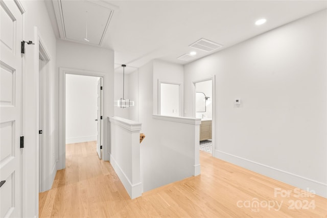 hallway with light hardwood / wood-style flooring