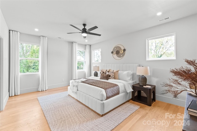 bedroom with light wood-type flooring and ceiling fan