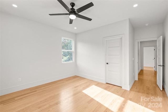 unfurnished room featuring light hardwood / wood-style floors and ceiling fan