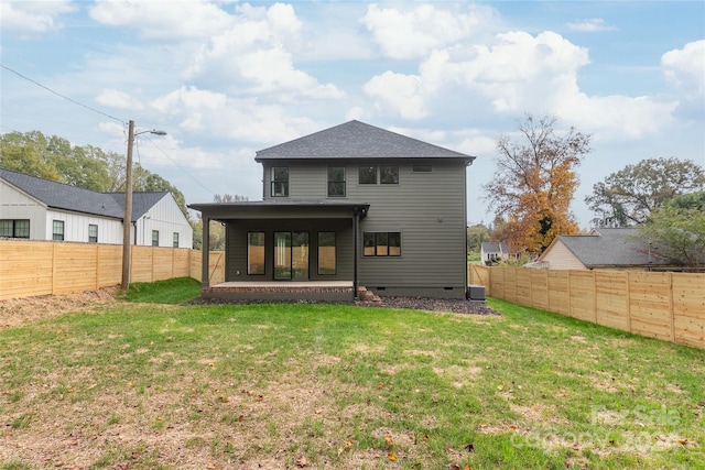 back of house featuring a yard