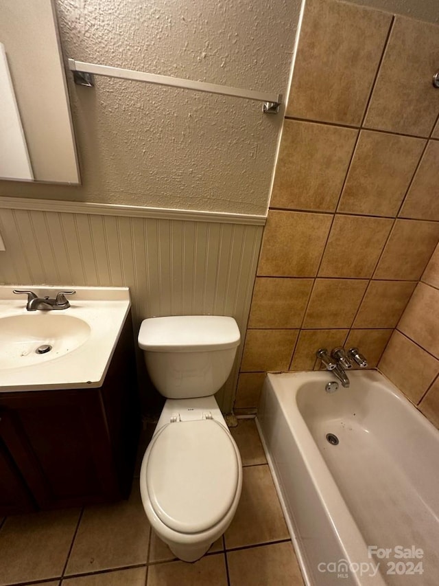 bathroom with vanity, toilet, tile patterned flooring, and a bathing tub