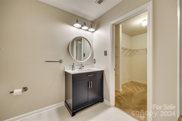 bathroom with tile patterned floors and vanity