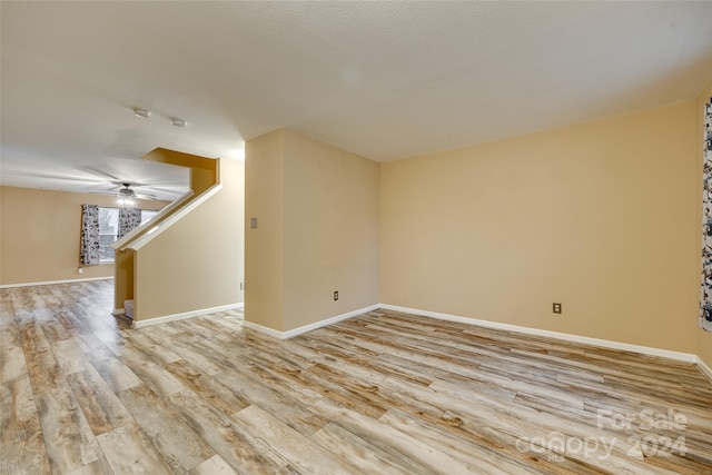 spare room with ceiling fan and light hardwood / wood-style floors