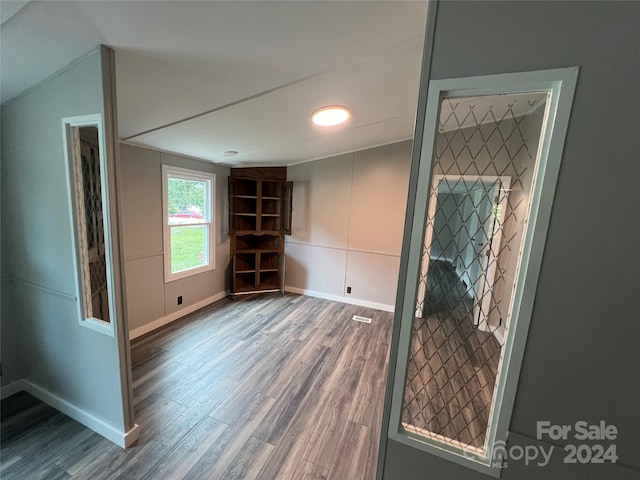 unfurnished room with hardwood / wood-style flooring