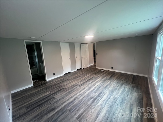 unfurnished room featuring dark hardwood / wood-style flooring