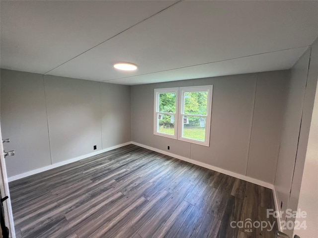 empty room with dark wood-type flooring