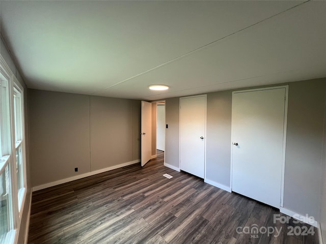 unfurnished bedroom featuring dark wood-type flooring