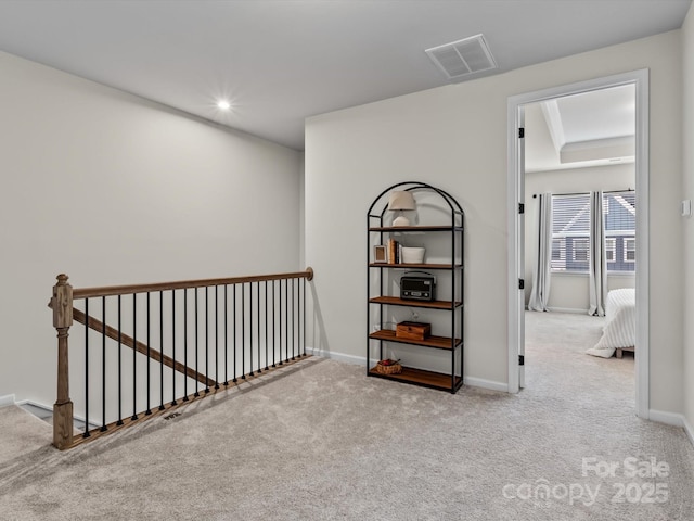 hallway featuring light carpet