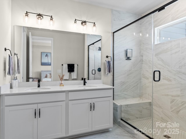 bathroom featuring vanity and a shower with shower door