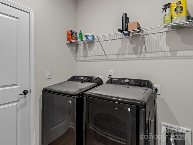 clothes washing area with independent washer and dryer