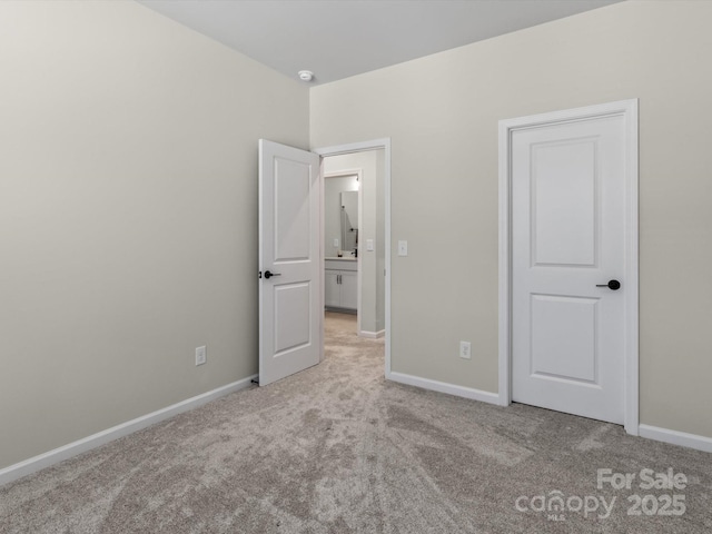 unfurnished bedroom featuring light carpet