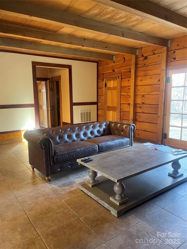 living room with beam ceiling, wooden ceiling, and wooden walls