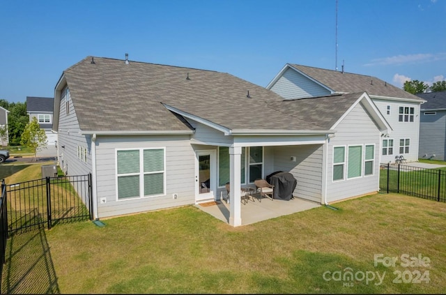 back of property featuring a yard and a patio