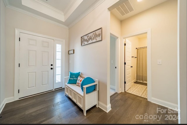 entryway featuring crown molding and dark wood-type flooring