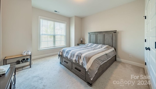 bedroom featuring light carpet