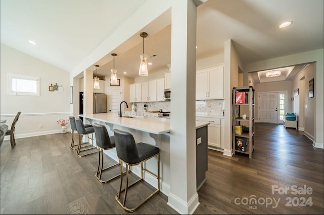 kitchen with dark hardwood / wood-style flooring, white cabinets, and a wealth of natural light