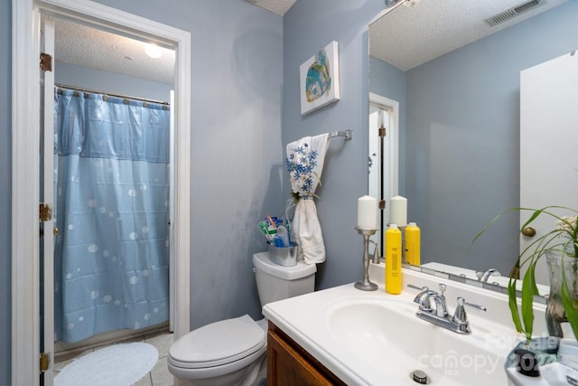 bathroom featuring vanity, a textured ceiling, a shower with curtain, and toilet