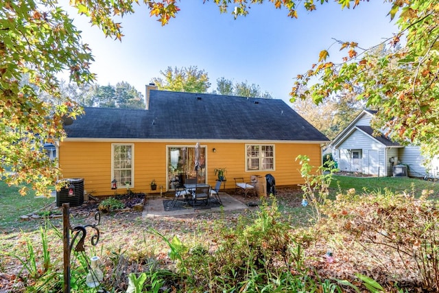 rear view of house with a patio and cooling unit