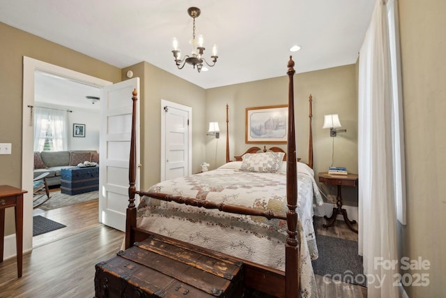 bedroom with dark wood-type flooring and a chandelier