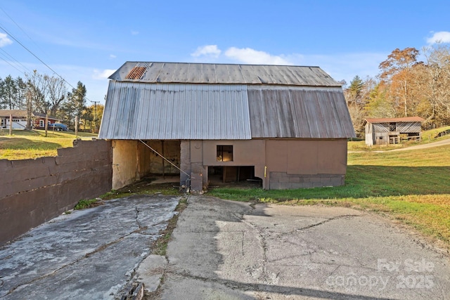 view of outbuilding featuring a lawn