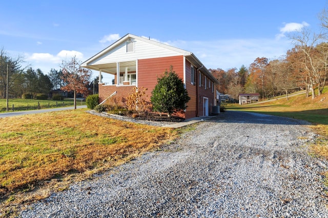 view of side of home with a garage and a lawn