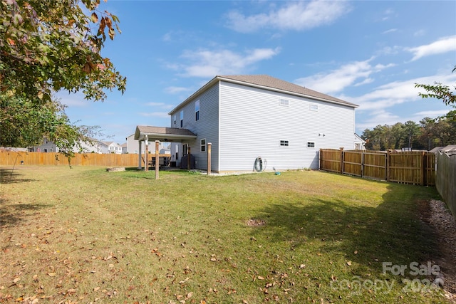 back of house featuring a yard