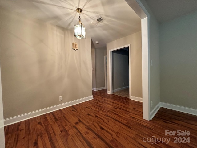 spare room with dark hardwood / wood-style flooring